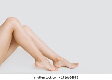young slender legs of a woman on a white background copy the space. the concept of depilation of the skin - Shutterstock ID 1916684993