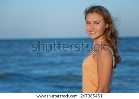 Young Slender Teen Girl With Flowing Long Hair On The Beach In The Summer Sun Young Slender Teen Girl With Flowing Long Hair On The Beach In The Summer Sun