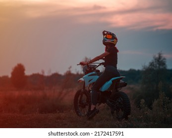 A Young Slender Woman In A Helmet On A Cross - Country Motorcycle Or Pit Bike . Moto Woman