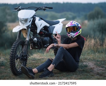 A Young Slender Woman In A Helmet On A Cross - Country Motorcycle Or Pit Bike . Moto Woman