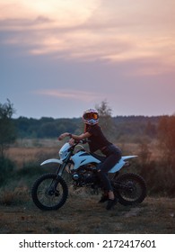 A Young Slender Woman In A Helmet On A Cross - Country Motorcycle Or Pit Bike . Moto Woman