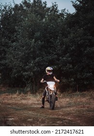 A Young Slender Woman In A Helmet On A Cross - Country Motorcycle Or Pit Bike . Moto Woman