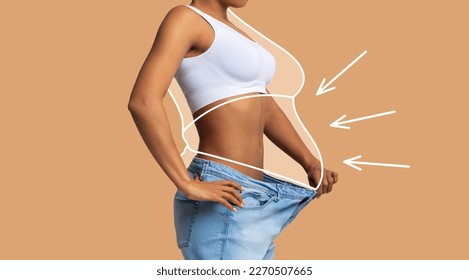 Young slim african american female in big jeans enjoy weight loss result with fat abstract body around, arrows isolated on beige wall background, studio. Diet, health and body care, before and after