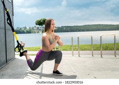 Young Slim Feamle Athlete Training Using Trx At Nature. Healthy Lifestyle. Make Your Body Machine