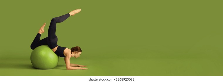 Young slim fit girl doing stretching exercises with fitness ball over green studio background. Concept of sport, body care, beauty, fitness, active lifestyle. Banner. Copy space for ad - Powered by Shutterstock