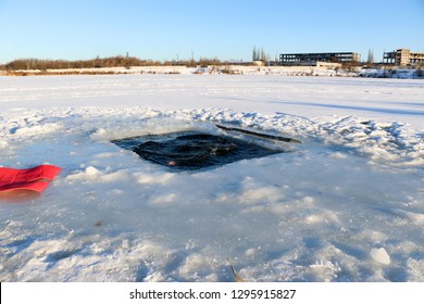 young, slim, handsome, sporty man with a red beard and long hair, naked, diving into ice-cold water in winter, against a snowy landscape, Ukraine, Shostka
