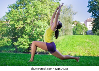 Young Slim Woman Doing Yoga Exercises In Park - Crescent Moon Pose