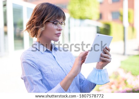 Young smart 20s caucasian university student woman using tablet in park