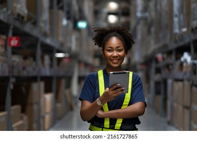 Young smart African American woman working in warehouse using the tablet for stock checking and inspection the boxes, logistic warehouse to deliver the shipment, happiness worker with smiling face - Shutterstock ID 2161727865