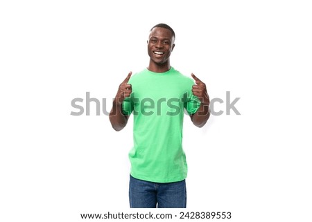 young smart african man dressed in a green t-shirt and jeans actively gesturing on a white background [[stock_photo]] © 