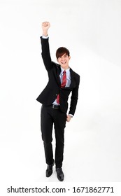 Young Smart Handsome Asian Man Business Office Wearing Suit Tie On White Background Look At Camera Walk Forward Fist Up Joy Success 