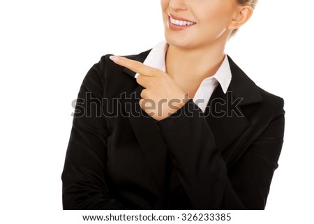 Young smiled businesswoman pointing her finger.