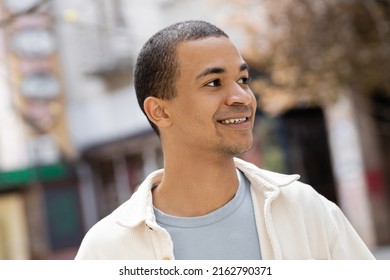 Young And Smiling African American Man In Shirt Jacket Looking Away Outside