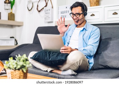 Young smiling asian man using laptop computer working and video conference online meeting with colleagues at home.Young creative man talk video call with business team.work from home concept - Powered by Shutterstock