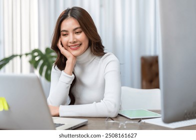 Young smiling asian woman relax using laptop conference work,learning education,study online,webinar podcast,creative woman looking at screen, shopping, online marketing at home - Powered by Shutterstock