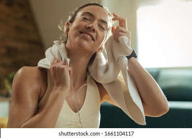 Young Smiling Athletic Woman Cleaning Sweat Of Her Face With A Towel. 