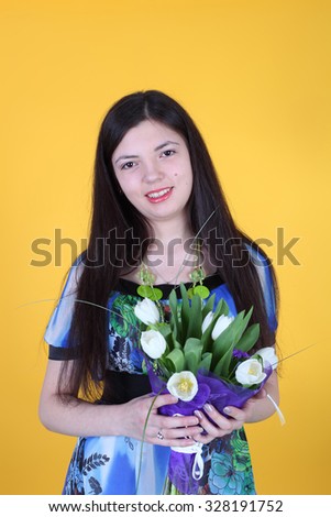 young smiling beautiful girl with the flowers