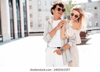 Young smiling beautiful woman and her handsome boyfriend in casual summer clothes. Happy cheerful family. Female having fun. Couple posing in the street background at sunny day. In sunglasses - Powered by Shutterstock