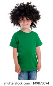 Young smiling boy in studio on white background with a big black funny wig.