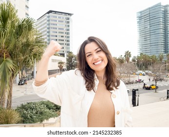 Young Smiling Business Woman Showing Off Biceps. Empowered Woman