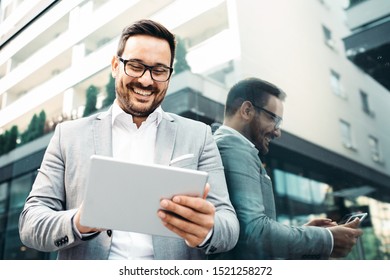 Young smiling businessman in front company building. - Shutterstock ID 1521258272