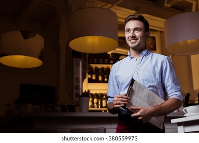 Young Smiling Businessman And His Small Restaurant