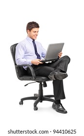 Young Smiling Businessman Sitting In Office Chair And Working On Laptop Computer Isolated On White Background