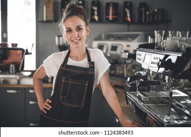 Young Smiling Cafe Business Owner Standing At Bar In Coffee Shop