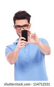 Young Smiling Casual Man Taking A Picture Of You With His Phone. Isolated On White Background