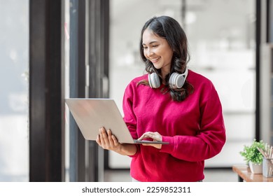 Young smiling caucasian Asian student freelancer woman using laptop for remote work, e-learning at university college, e-banking, online shopping,  - Powered by Shutterstock