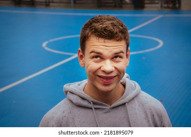Young Smiling Caucasian Man Making Funny Face Expression Having Fun On Basketball Court. Emotional Portrait Of An Athlete, Good Vibes Only, Positive Energy
