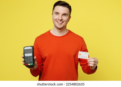 Young smiling caucasian man wearing orange casual clothes hold wireless modern bank payment terminal to process acquire credit card isolated on plain yellow color background. People lifestyle concept - Shutterstock ID 2254802633