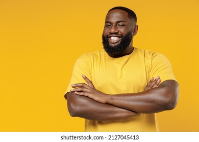 Young smiling cheerful satisfied positive happy black man 20s wear bright casual t-shirt hold hands crossed folded isolated on plain yellow color background studio portrait. People lifestyle concept - Shutterstock ID 2127045413