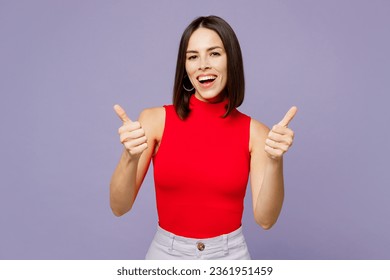 Young smiling cool hapy fun cheerful positive fun woman she wears red shirt casual clothes showing thumb up like gesture isolated on plain pastel green background studio portrait. Lifestyle concept