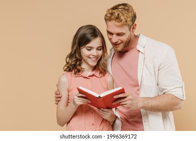 Young smiling cool parent man have fun with cute child teen girl in casual pastel clothes Daddy little kid daughter reading book together isolated on beige background. Father's Day Love family concept - Powered by Shutterstock