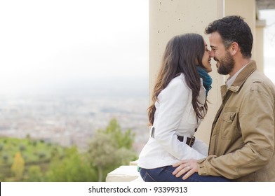 Young smiling couple embraced