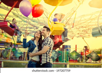 Young smiling couple having a ride on a ferris wheel