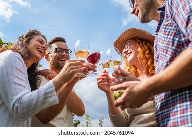 Young smiling couple tasting wine at winery vineyard - Friendship and love concept with young people enjoying harvest time  - Powered by Shutterstock