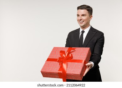 Young Smiling Employee Business Corporate Lawyer Man 20s Wearing Classic Black Grey Suit Shirt Tie Work In Office Hold Red Present Box With Gift Ribbon Bow Isolated On White Background Studio Portrait