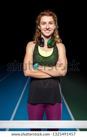 Similar – Close up front upper body portrait of one middle age athletic woman in sportswear in gym over dark background, looking at camera and smiling