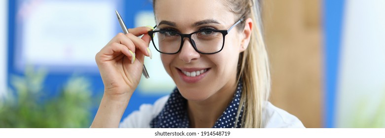 Young Smiling Female Doctor Holds Medicine In Her Hand. New Drug Development