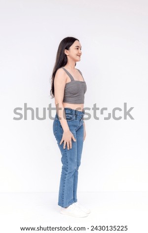 A young, smiling Filipino woman posing in casual clothes, exuding confidence and a relaxed, approachable vibe.