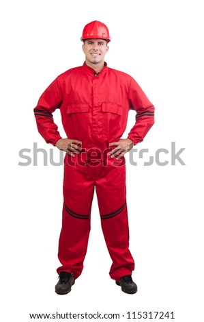 Young smiling fireman or construction worker with hard hat and in full uniform isolated on white.