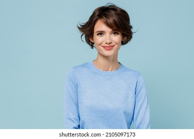 Young smiling fun happy caucasian european attractive cute woman 20s in casual sweater looking camera isolated on plain pastel light blue color background studio portrait. People lifestyle concept. - Shutterstock ID 2105097173