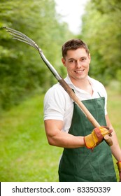 Young And Smiling Gardener With Pitchfork