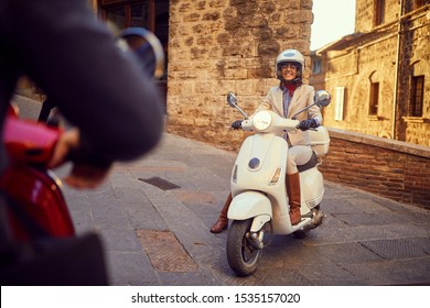 Young  Smiling Girl On Vespa Scooter At City. Bikers.