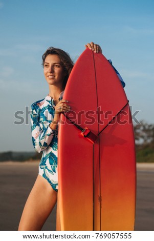 Similar – Young surfer woman with top and bikini holding surfboard