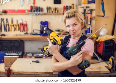 Young Smiling Handy Woman With Short Blond Hair Working With Screwdriver. 