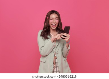 Young smiling happy asian woman 20s using mobile cell phone wow face looking isolated on pink copy space background. - Powered by Shutterstock