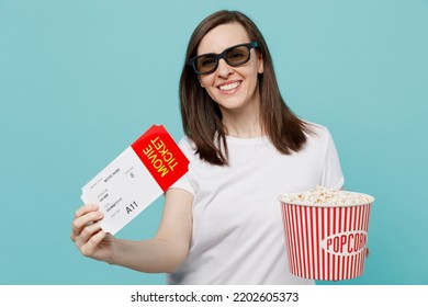 Young Smiling Happy Cheerful Cool Woman In 3d Glasses Watch Movie Film Hold Bucket Of Popcorn In Cinema Holding Ticket Look Camera Isolated On Plain Pastel Light Blue Cyan Background Studio Portrait